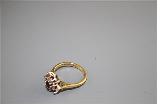 A modern 18ct gold, ruby and diamond set flower head cluster ring, size I, gross weight 3.7 grams.